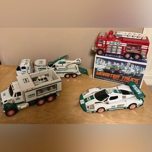 Hess Collectible vehicles with smaller accessory motor cycles, race car, fite